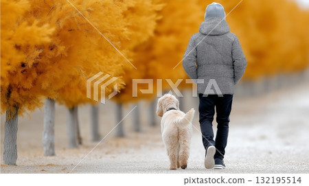 Male walking dog in autumn park with vibrant orange trees 132195514