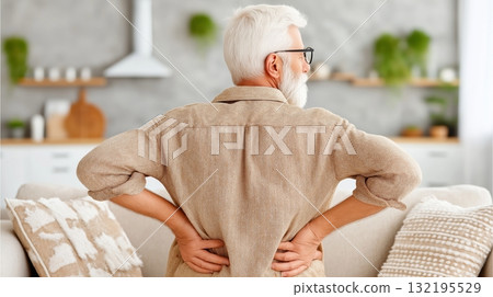Elderly caucasian male with back pain in cozy living room Elderly caucasian male with back pain in cozy living room 132195529