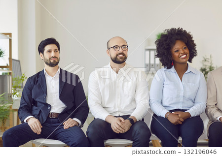 Multicultural group of business people sitting in a row, close-up 132196046