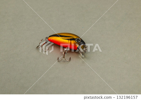 Brightly colored fishing lure on a neutral background Brightly colored fishing lure on a neutral background 132196157