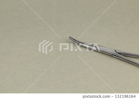 Tweezers placed on a light surface for precise tasks in a workspace Tweezers placed on a light surface for precise tasks in a workspace 132196164