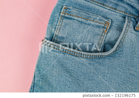 Close-up of denim jeans pocket against a pink background 132196175