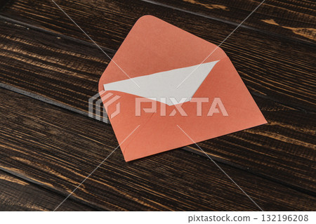 Colorful envelope placed on a wooden table showcasing creativity and craft 132196208