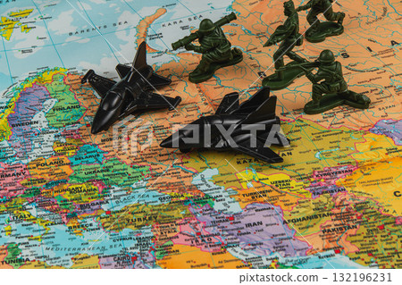 Military toys on a world map highlighting strategic locations 132196231