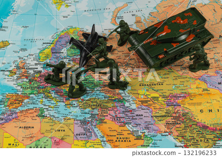 Military toy figures on colorful map playing out a strategic battle scene 132196233