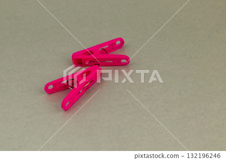 Vibrant pink clothespins arranged on a textured surface Vibrant pink clothespins arranged on a textured surface 132196246