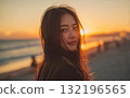 一個女人轉身，海灘上的日落 132196565