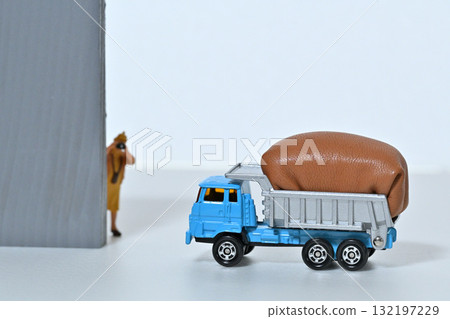 A woman photographs a fully loaded dump truck A woman photographs a fully loaded dump truck 132197229