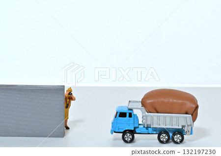 A woman photographs a fully loaded dump truck A woman photographs a fully loaded dump truck 132197230