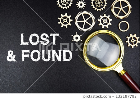 Lost And Found text message with magnifying glass on black background Lost And Found text message with magnifying glass on black background 132197792