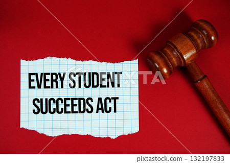 Every Student Succeeds Act text written on rip paper with wooden judgment gavel on red background Every Student Succeeds Act text written on rip paper with wooden judgment gavel on red background 132197833