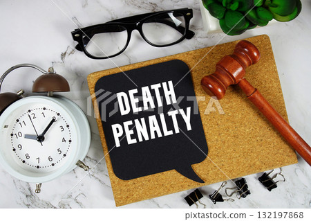 Death Penalty text on speech bubble with alarm clock and wooden gavel on marble background Death Penalty text on speech bubble with alarm clock and wooden gavel on marble background 132197868