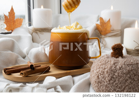 Pumpkin spiced latte morning warming coffee. Fall Drinks for Halloween Thanksgiving Holiday beverage Autumn spicy cinnamon flavor seasonal hot drinking in cozy orange cup. Atmosphere of cold rainy Pumpkin spiced latte morning warming coffee. Fall Drinks for Halloween Thanksgiving Holiday beverage Autumn spicy cinnamon flavor seasonal hot drinking in cozy orange cup. Atmosphere of cold rainy 132198122