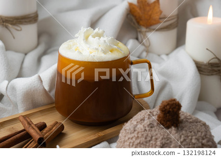 Autumn hygge Orange Cup of warm coffee autumn leaves on table against raindrops are running down the glass in window. Cozy fall still life footage burning candles. Thanksgiving and Halloween holiday 132198124
