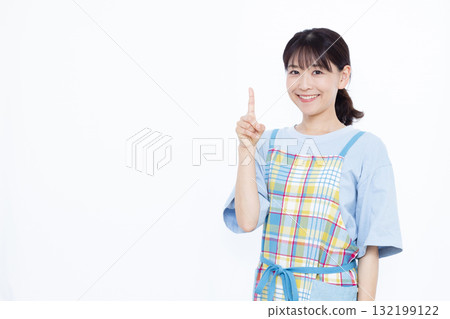 A housewife in an apron pointing up A housewife in an apron pointing up 132199122