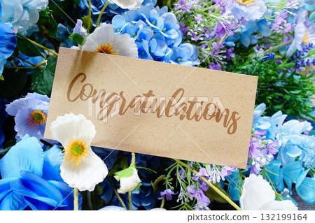 Congratulations text write on paper card with flowers decoration on wooden background Congratulations text write on paper card with flowers decoration on wooden background 132199164