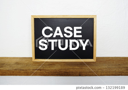 Case Study text written on blackboard with wooden shelf and concrete background 132199189