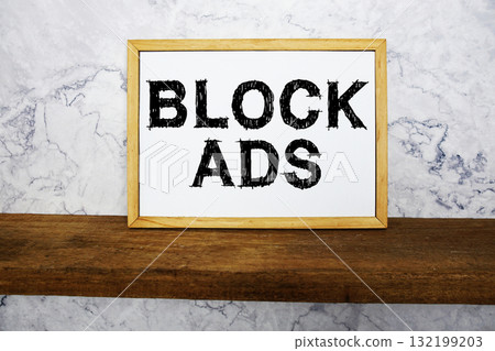 Block Ads text written on whiteboard with wooden shelf and marble background Block Ads text written on whiteboard with wooden shelf and marble background 132199203