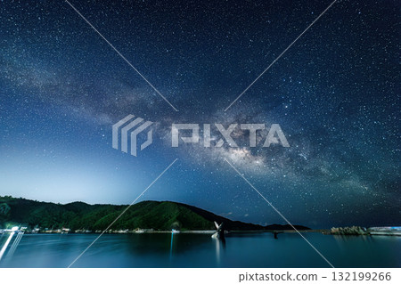 Long exposure starry sky photography on the beach with the humpback whale statue. The Milky Way and shooting stars were visible. Fishing boats and other things were visible in the harbor. Zamami Island 132199266