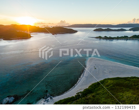 Aerial photography of the sunrise over the Kerama Islands from Zamami Port using a drone. Zamami Port, Zamami Island, Kerama Islands, Shimajiri District, Okinawa Prefecture Aerial photography of the sunrise over the Kerama Islands from Zamami Port using a drone. Zamami Port, Zamami Island, Kerama Islands, Shimajiri District, Okinawa Prefecture 132199435
