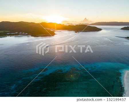 Aerial photography of the sunrise over the Kerama Islands from Zamami Port using a drone. Zamami Port, Zamami Island, Kerama Islands, Shimajiri District, Okinawa Prefecture Aerial photography of the sunrise over the Kerama Islands from Zamami Port using a drone. Zamami Port, Zamami Island, Kerama Islands, Shimajiri District, Okinawa Prefecture 132199437