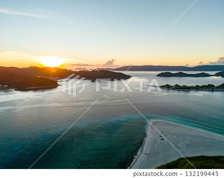 Aerial photography of the sunrise over the Kerama Islands from Zamami Port using a drone. Zamami Port, Zamami Island, Kerama Islands, Shimajiri District, Okinawa Prefecture Aerial photography of the sunrise over the Kerama Islands from Zamami Port using a drone. Zamami Port, Zamami Island, Kerama Islands, Shimajiri District, Okinawa Prefecture 132199445