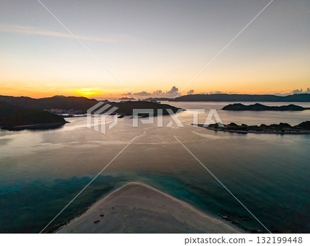 Aerial photography of the sunrise over the Kerama Islands from Zamami Port using a drone. Zamami Port, Zamami Island, Kerama Islands, Shimajiri District, Okinawa Prefecture 132199448
