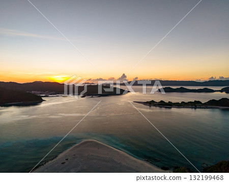 Aerial photography of the sunrise over the Kerama Islands from Zamami Port using a drone. Zamami Port, Zamami Island, Kerama Islands, Shimajiri District, Okinawa Prefecture 132199468