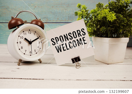 Sponsors Welcome text written on paper card with alarm clock on wooden background Sponsors Welcome text written on paper card with alarm clock on wooden background 132199607