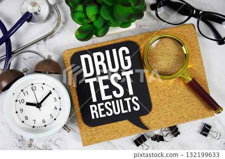 Drug Test Results text with alarm clock, calculator and stethoscope on marble background 132199633