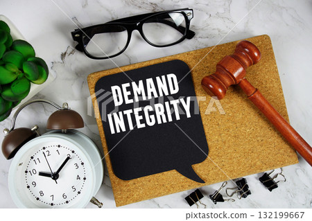 Demand Integrity text on speech bubble with alarm clock and wooden gavel on marble background 132199667