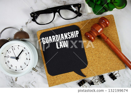 Guardianship Law text on speech bubble with alarm clock and wooden gavel on marble background 132199674