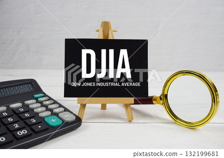 DJIA abbreviation of Dow Jones Industrial Average text with magnifying glass and calculator on wooden background DJIA abbreviation of Dow Jones Industrial Average text with magnifying glass and calculator on wooden background 132199681