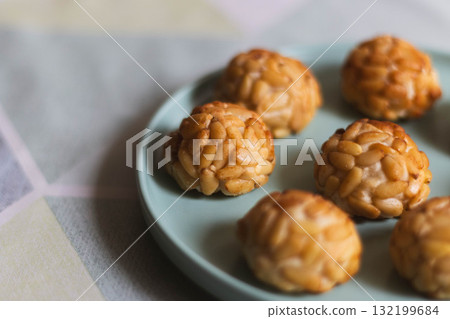 Traditional Catalan pine nut sweets panellets on a pastel plate 132199684