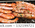 Grilled prawns with garlic and parsley on a barbecue 132199721