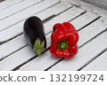 Fresh eggplant and red bell pepper on a rustic white wooden table 132199724