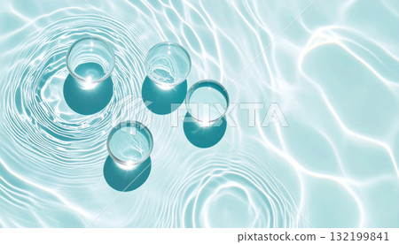 Transparent glass spheres on a blue water surface with caustic light reflections. 132199841