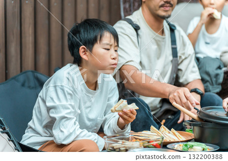 Family eating on a wooden deck (glamping, outdoor, villa, cottage) Family eating on a wooden deck (glamping, outdoor, villa, cottage) 132200388