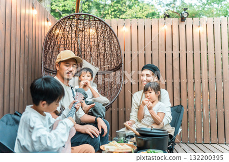 Family eating on a wooden deck (glamping, outdoor, villa, cottage) Family eating on a wooden deck (glamping, outdoor, villa, cottage) 132200395