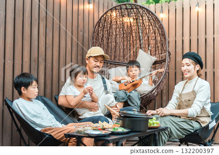 Family eating on a wooden deck (glamping, outdoor, villa, cottage) Family eating on a wooden deck (glamping, outdoor, villa, cottage) 132200397