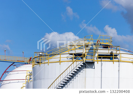White crude oil storage tanks at petroleum refinery industrial plant, Fuel gas containers in factory area, Energy industry infrastructure, Oil and Gas storage tank blue sky background. 132200408