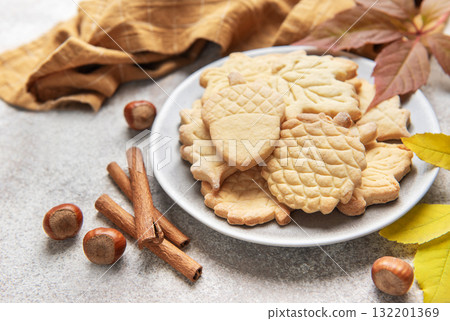 Autumn cookies on plate with cinnamon and hazelnuts Autumn cookies on plate with cinnamon and hazelnuts 132201369
