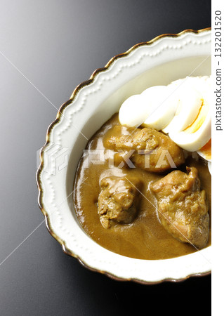 Chicken curry with boiled egg on a black background 132201520