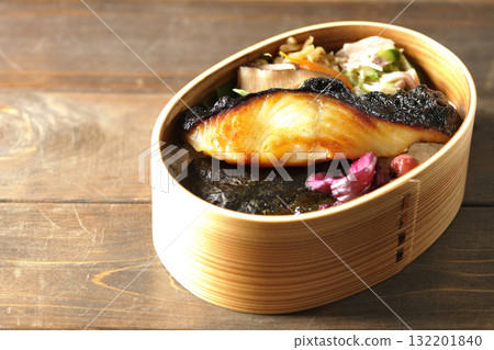 A bento lunch box with seaweed and grilled silver cod in a bento box. 132201840