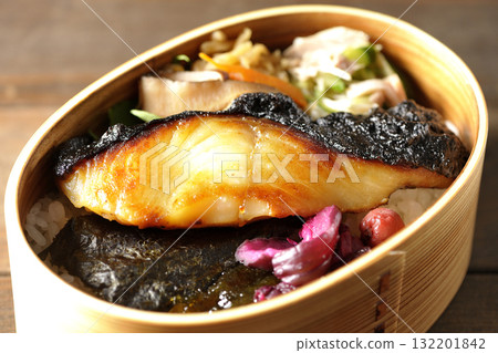 A bento lunch box with seaweed and grilled silver cod in a bento box. A bento lunch box with seaweed and grilled silver cod in a bento box. 132201842
