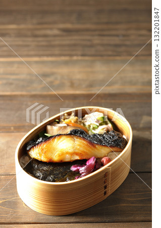 A bento lunch box with seaweed and grilled silver cod in a bento box. A bento lunch box with seaweed and grilled silver cod in a bento box. 132201847