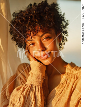 Young woman smiling in golden hour sunlight 132202025