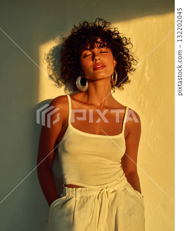 Woman enjoying golden hour sunlight on face 132202045