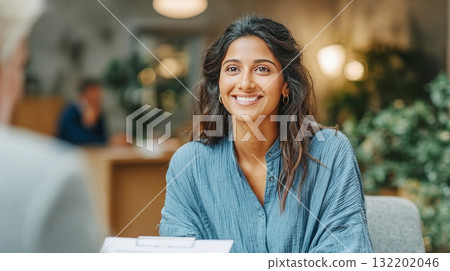 Young woman smiling during a professional job interview Young woman smiling during a professional job interview 132202046