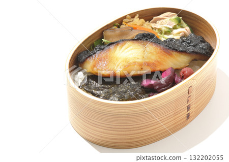A bento lunch box with seaweed and grilled silver cod served in a bento box, photographed against a white background 132202055